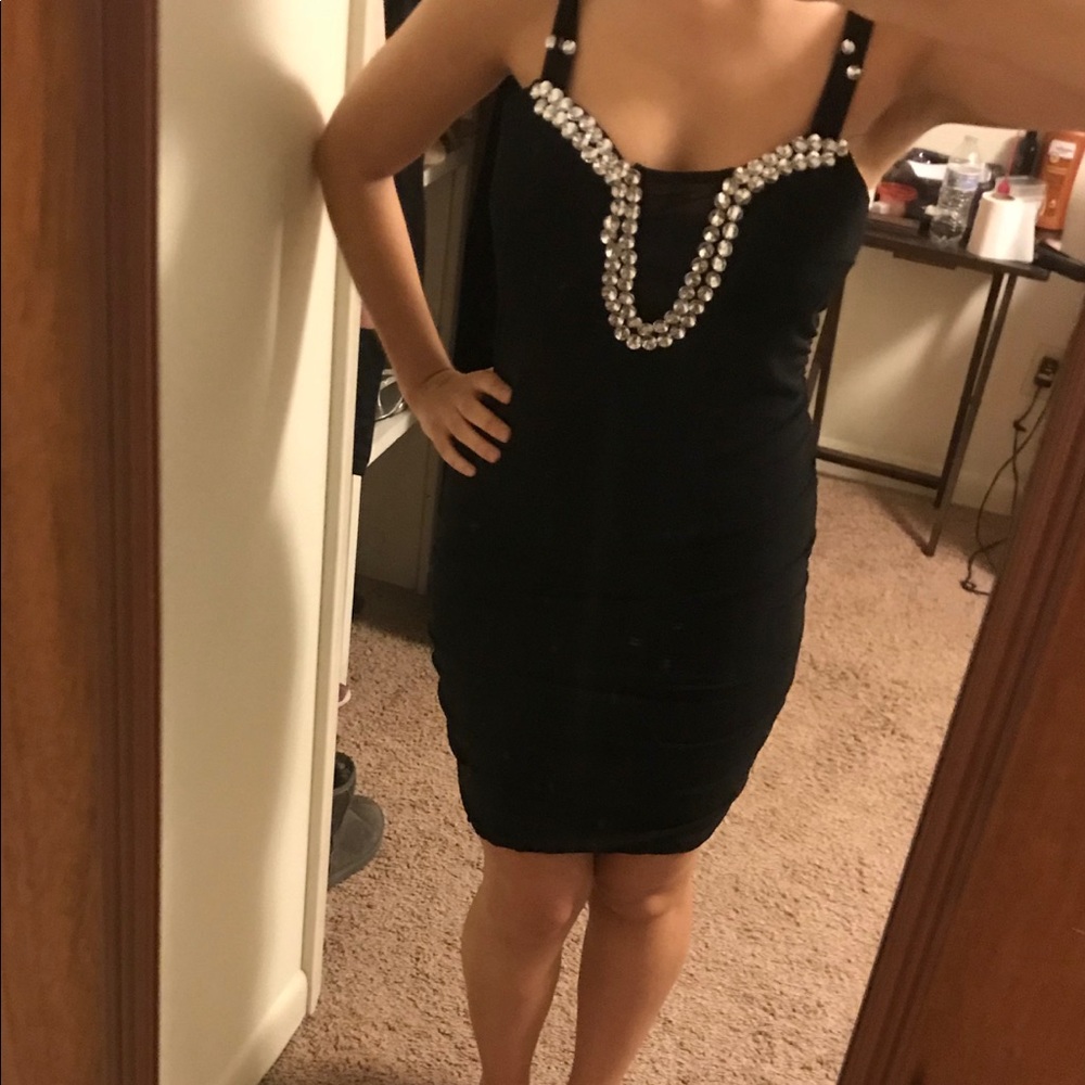 Black dress . Rhinestones in the center .